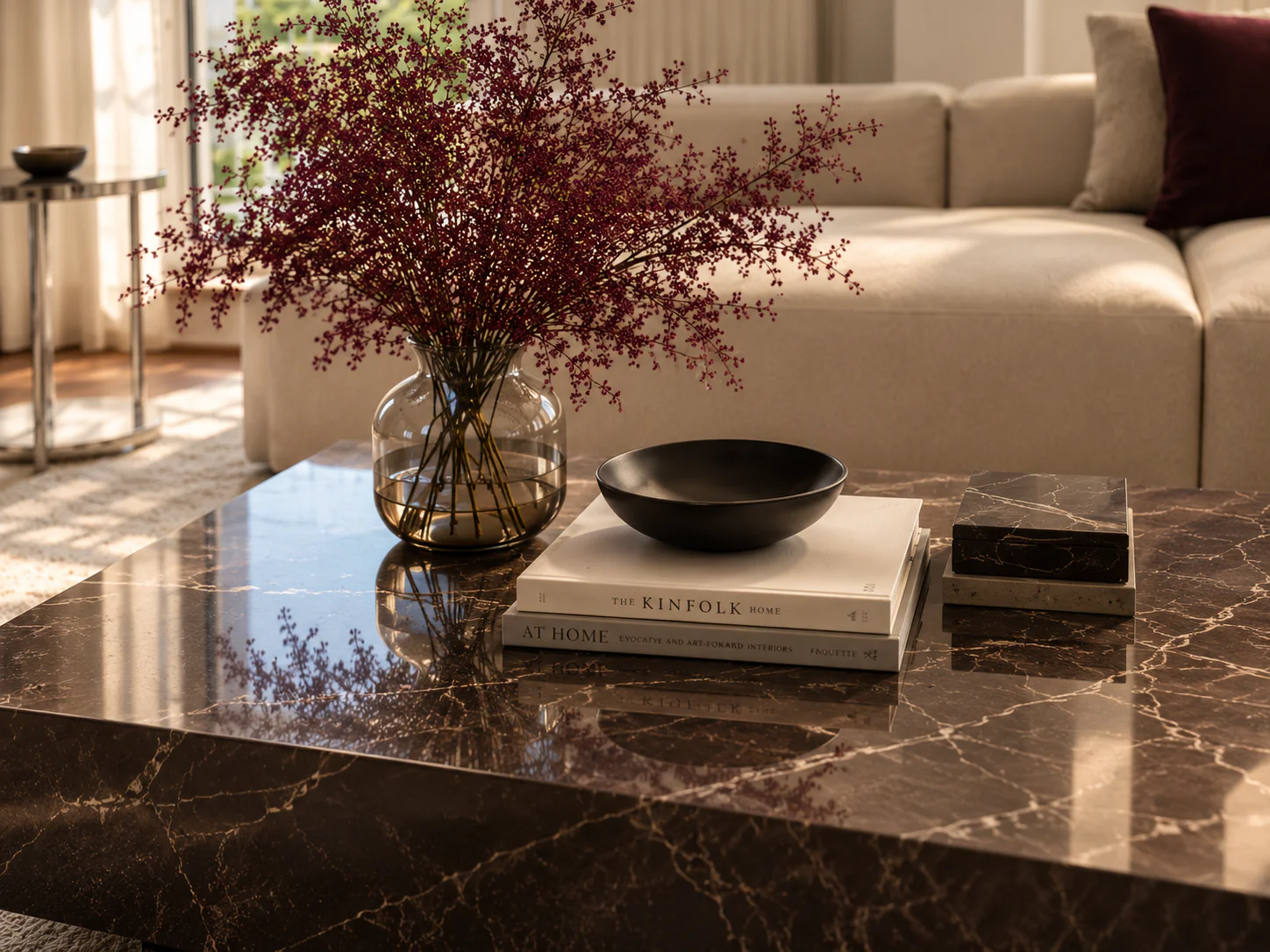 Stylish living room with flowers and design books